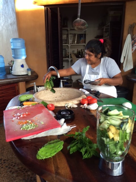 Olga washing freshly-picked veg from the garden.